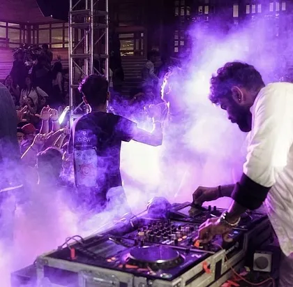 Surrounded by purple smoke and stage lights while mixing at the Under 25 Summit. I use full production elements like smoke machines to build a powerful visual and atmospheric experience.