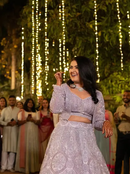 Pure joy captured during the Sangeet night. The bride's makeup is radiant and her hair is styled for movement.