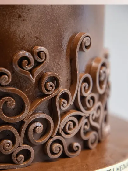 This detailed shot showcases the handcrafted chocolate scrollwork, featuring delicate heart shapes. It's these personal, artistic touches that make my chocolate creations more than just a dessert.