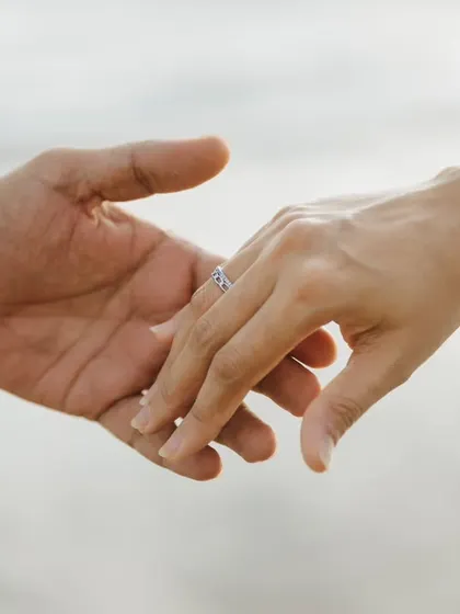 A simple, elegant photograph focusing on the promise of forever. This close-up of the engagement ring is a classic shot that symbolizes the beginning of your new journey together.