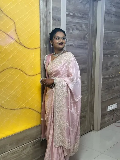 A full shot of the bride against a vibrant background. The makeup stands out beautifully without looking heavy.