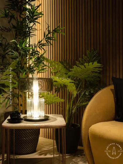 An elegant table lamp designed with a fluted crystal base and a smoked glass upper shade. This piece combines classic materials with a modern form to create a sophisticated light source for a living room or bedroom.