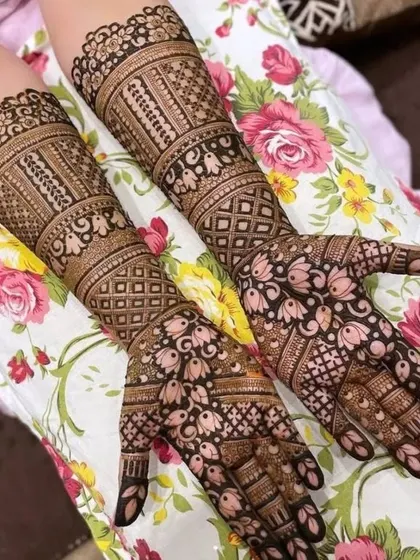 This is a heavy, intricate design perfect for a bride or a big festival. It covers the hands and extends up the arms with dense patterns, including lotus motifs, checks, and detailed finger work.