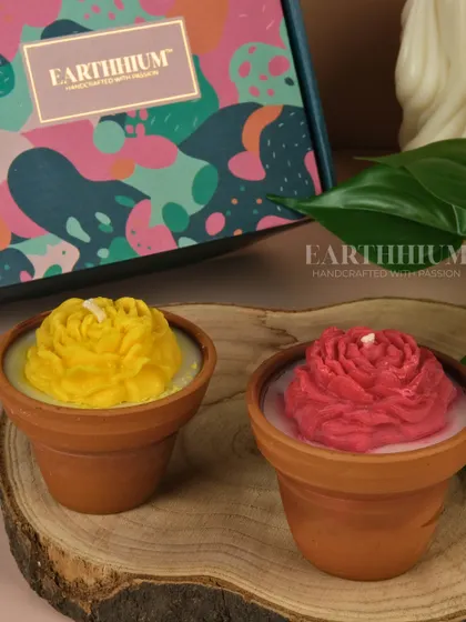 My floral candle set in terracotta pots, featuring a bright yellow and a deep red rose. These come beautifully packaged in a colorful gift box.