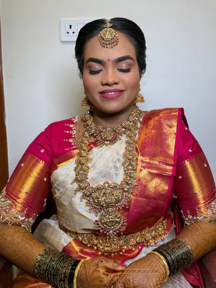 My beautiful bride Harshitha, ready for her muhurtham. This look features a matte finish, traditional temple jewellery, and a classic bridal braid for a timeless look.