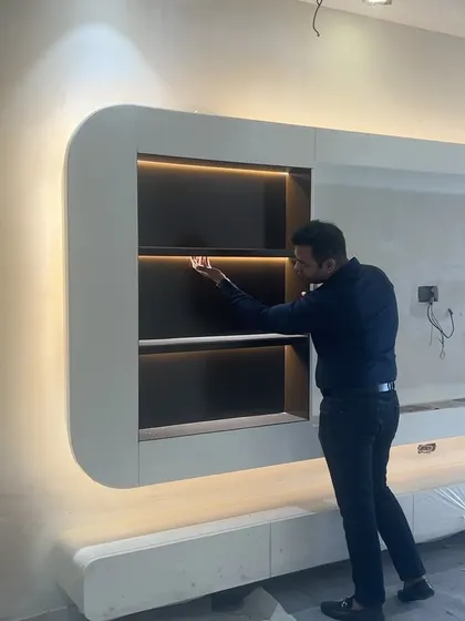 Doing a final check on the alignment and lighting of this curved TV unit before handover.