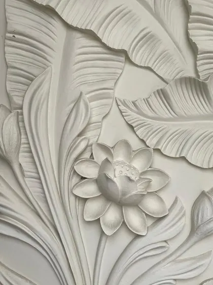 A beautiful 3D floral wallpaper that adds texture and a delicate, sculptural quality to the wall.