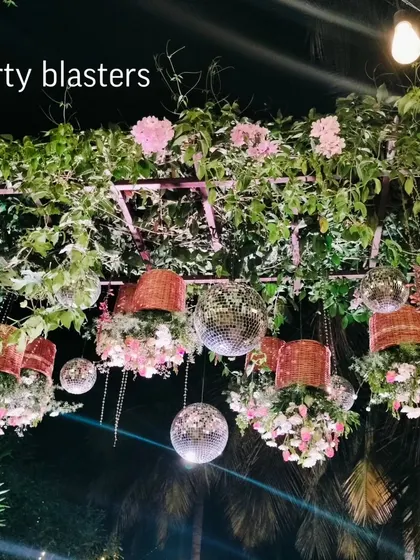 A unique wedding decor concept with hanging disco balls and floral baskets. This creates a fun, festive, and glamorous ceiling treatment for an outdoor reception.