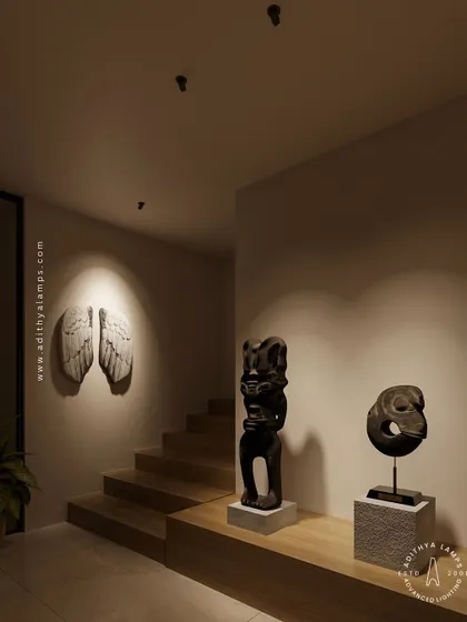Our nearly invisible recessed spotlights create a gallery-like feel in this hallway. The focused light beautifully accentuates the angel wings wall sculpture and the tribal statues, demonstrating how minimal fixtures can produce maximum impact.