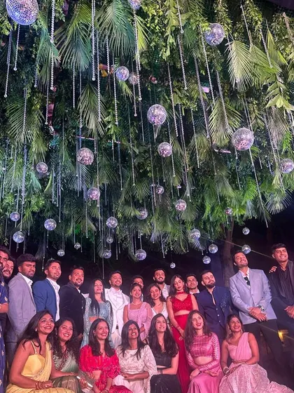 A group photo capturing the happy faces of friends and family at the end of a memorable sangeet night.