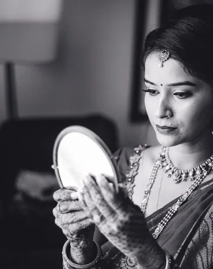 A bride's quiet moment of reflection in the mirror before the ceremony begins. This black and white shot is full of anticipation and grace.