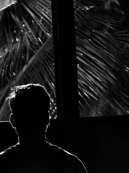 A silhouette of a fighter in thought. Boxing requires you to look inward and confront your own limits.