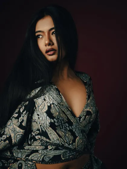 A classic beauty portrait with a three-quarter turn and flowing hair.