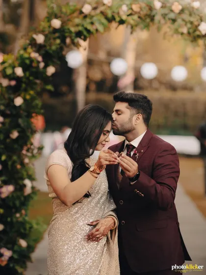 A tender moment during the ring exchange, with the groom kissing the bride's forehead. This shot beautifully captures the love and promise of an engagement.