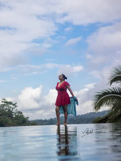 Capturing the feeling of freedom at the edge of an infinity pool in Ubud. I used the reflection in the water and the vast sky to create a sense of serenity and escape for this solo travel portrait.