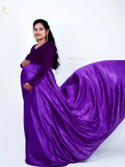 The flowing satin skirt of the purple gown in action. This is a great way to add movement and life to your maternity photos.
