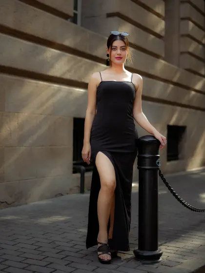 A full-length view of the elegant black dress against a classic stone building, showing how I frame shots to include architectural elements.