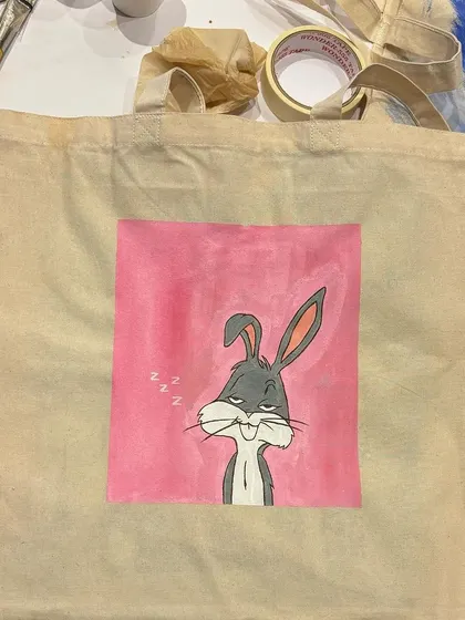 A sleepy Bugs Bunny painted on a tote bag. We love when guests bring their own fun and quirky ideas to our open house workshops.