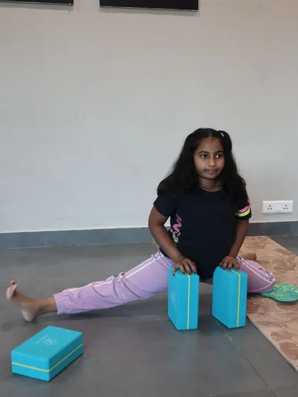 Using blocks for support is a smart way to work on splits. This student is learning to open her hips gradually and safely.