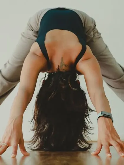 A wide-legged forward fold, Prasarita Padottanasana. This inversion calms the mind while stretching the hamstrings and spine.