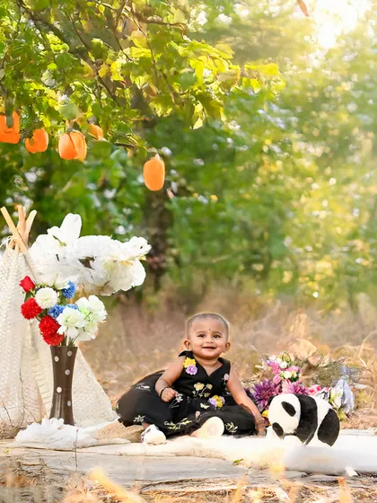 A whimsical teepee setup in a sunlit field. Outdoor sessions allow for creative and natural setups like this one, perfect for capturing a child's sense of wonder and adventure.