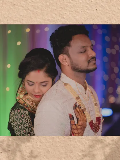 A quiet, serene moment amidst the reception festivities. The bride rests her head on the groom's back, a simple gesture full of love and trust.