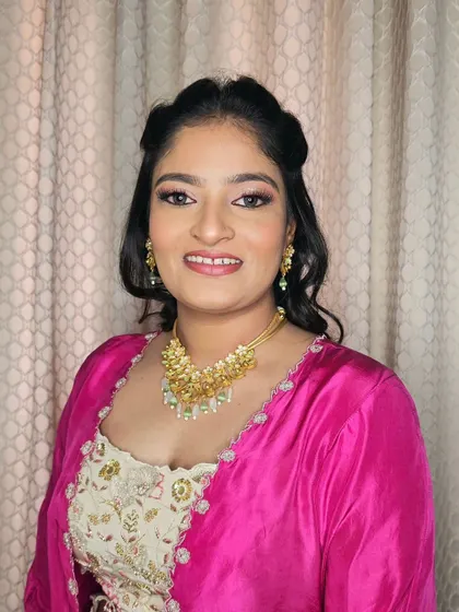 Neha, looking radiant with glowing skin and sparkling eyes for a wedding event.