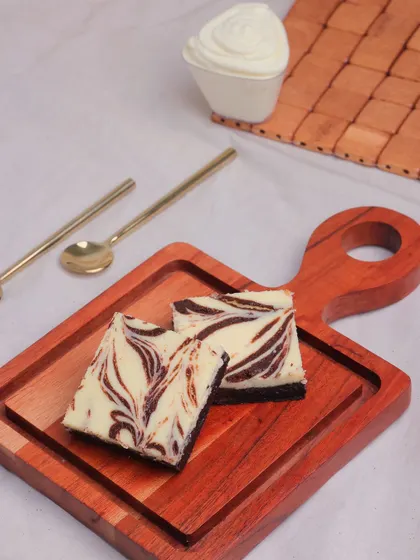 Another angle of our Cheesecake Brownies, highlighting the beautiful swirl pattern created by combining the two batters.