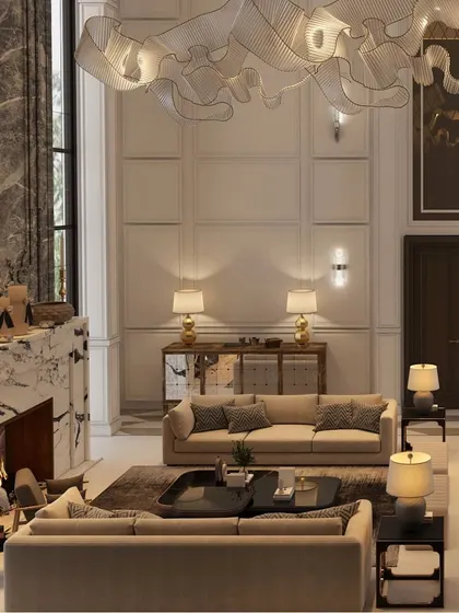 This living room showcases a modern and grand design with soaring ceilings and luxurious details. The space feels open and opulent, with a statement marble fireplace and a sculptural light fixture that draws the eye upward.
