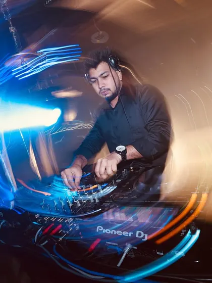 A cool long-exposure shot capturing the energy and motion of a wedding DJ set.