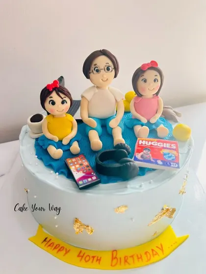 A cake celebrating family and turning 40, with custom fondant figures.