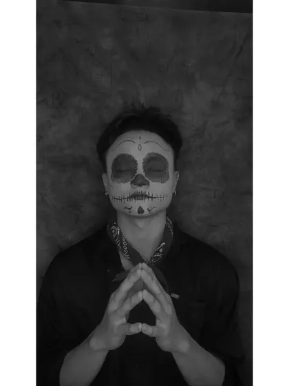 The same Coco-inspired skull makeup, shown in black and white to emphasize the linework and shading. This view highlights the contouring used to create the hollowed-out effect.