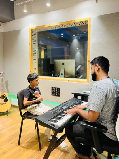A young student in a vocal and keyboard lesson. We ensure our instructors provide personalized attention, which is why our classes never have more than two students.