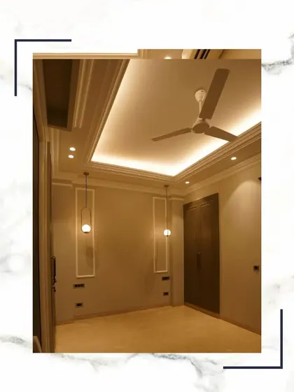 We embark on a journey of lavish living, and the bedroom is a key part of that. This space features elegant pendant lighting, a false ceiling, and a solid wooden wardrobe.