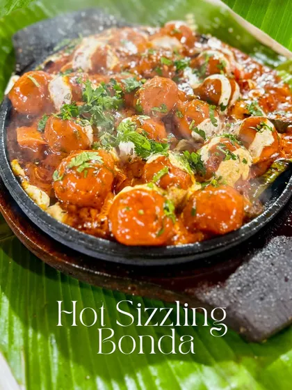 My Hot Sizzling Bonda is a treat for the senses. Soft potato bondas are tossed in a spicy peri peri sauce and served on a sizzling platter that fills the air with an irresistible aroma.