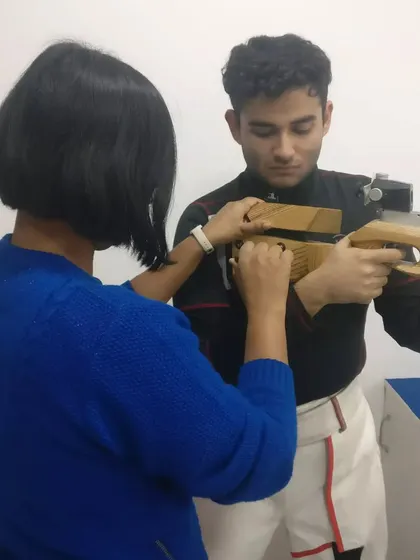 Our Junior Coach and National Shooter, Sapna Kumari, provides one-on-one guidance to a promising rifle shooter. This mentorship is crucial for developing competitive athletes.