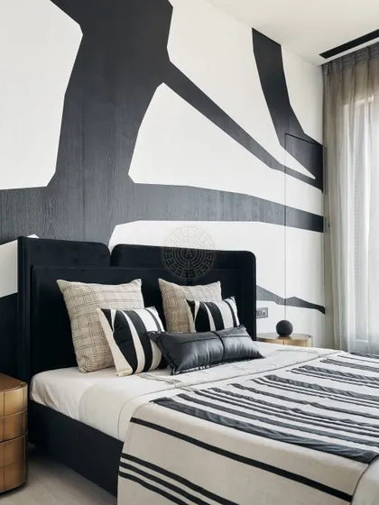 Part of the 'Yin-Yang' project, this bedroom embraces the 'Yang' side with a bold, abstract black and white mural. The monochrome palette is continued in the bedding, creating a cohesive and stylish look.
