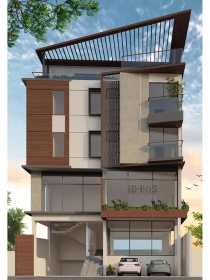 A frontal view of the mixed-use project, highlighting the rooftop pergola and the contrast between concrete and wood.