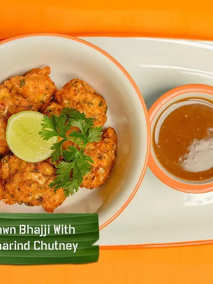 My Prawn Bhajji is a perfect starter. Fresh prawns are mixed in a spiced batter and fried until golden, served with a tangy tamarind chutney for dipping.