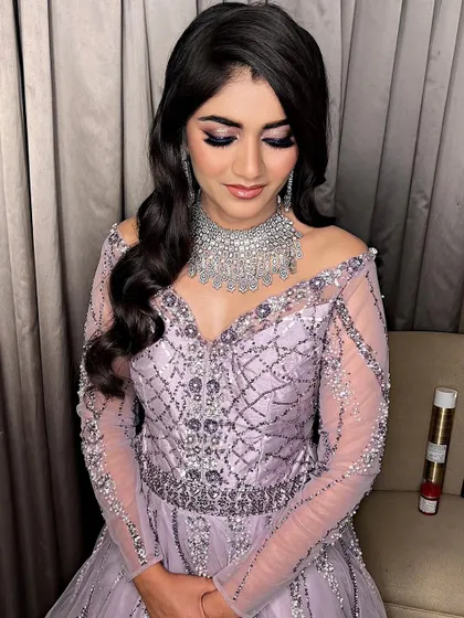 A beautiful cocktail glam look in a lavender gown. The makeup features a dramatic purple smokey eye that makes her eyes pop.