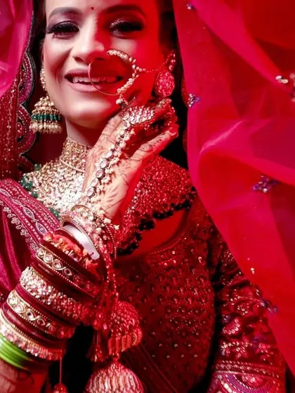 A beautiful bridal portrait taken through a red veil, creating a soft and romantic effect.