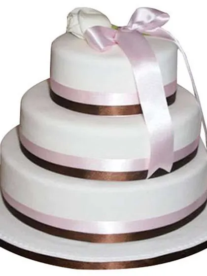 We create elegant multi-tiered cakes for your grand celebrations like weddings, engagements, or milestone anniversaries. This three-tier fondant cake shows a clean, classic design that can be customized for any large event.
