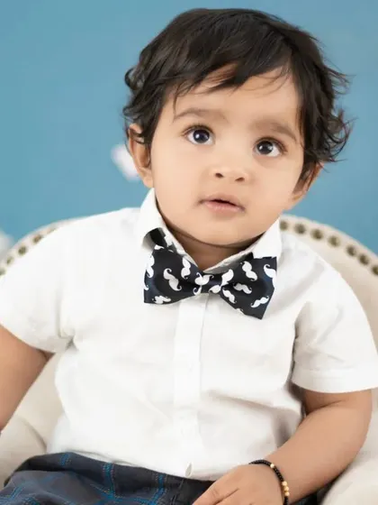 This little man is rocking the Boss Baby look with a mustache-print bow tie. We pay attention to every stylish detail.