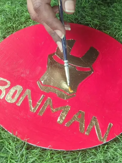 An Iron Man design being created with gold foil. A great way to pay homage to your favorite superhero.