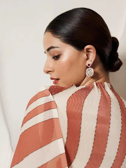 Ananya Panday showcasing the handcrafted micromosaic Cherry Blossom earrings. The design features natural Mozambique rubies and diamonds, set in 18k gold to create a piece that is both modern and timeless.