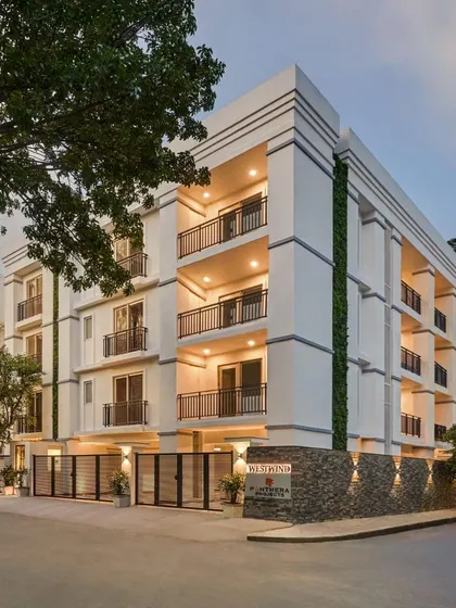 The Panthera Westwind apartment building in Indiranagar features a clean, white facade with classical proportions, offering a timeless and elegant look.