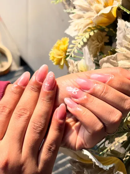 A delicate and pretty design on a sheer pink base, featuring tiny, hand-painted white bows and sparkles.