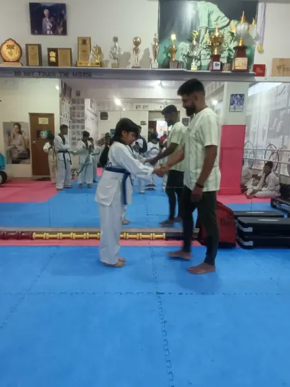 A handshake and a bow, the traditional way to show respect after receiving a new belt.