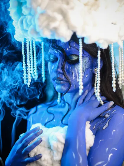 A serene and melancholic pose, with smoke effects adding to the atmosphere.