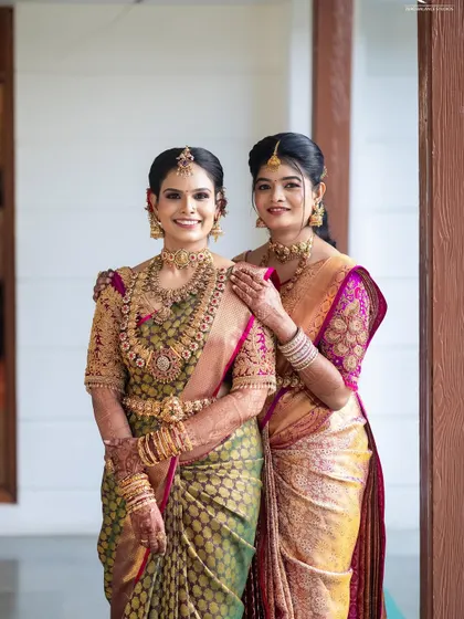 A beautiful portrait of two sisters. I draped both their sarees to complement each other, creating a coordinated look that is perfect for family photos at a wedding.